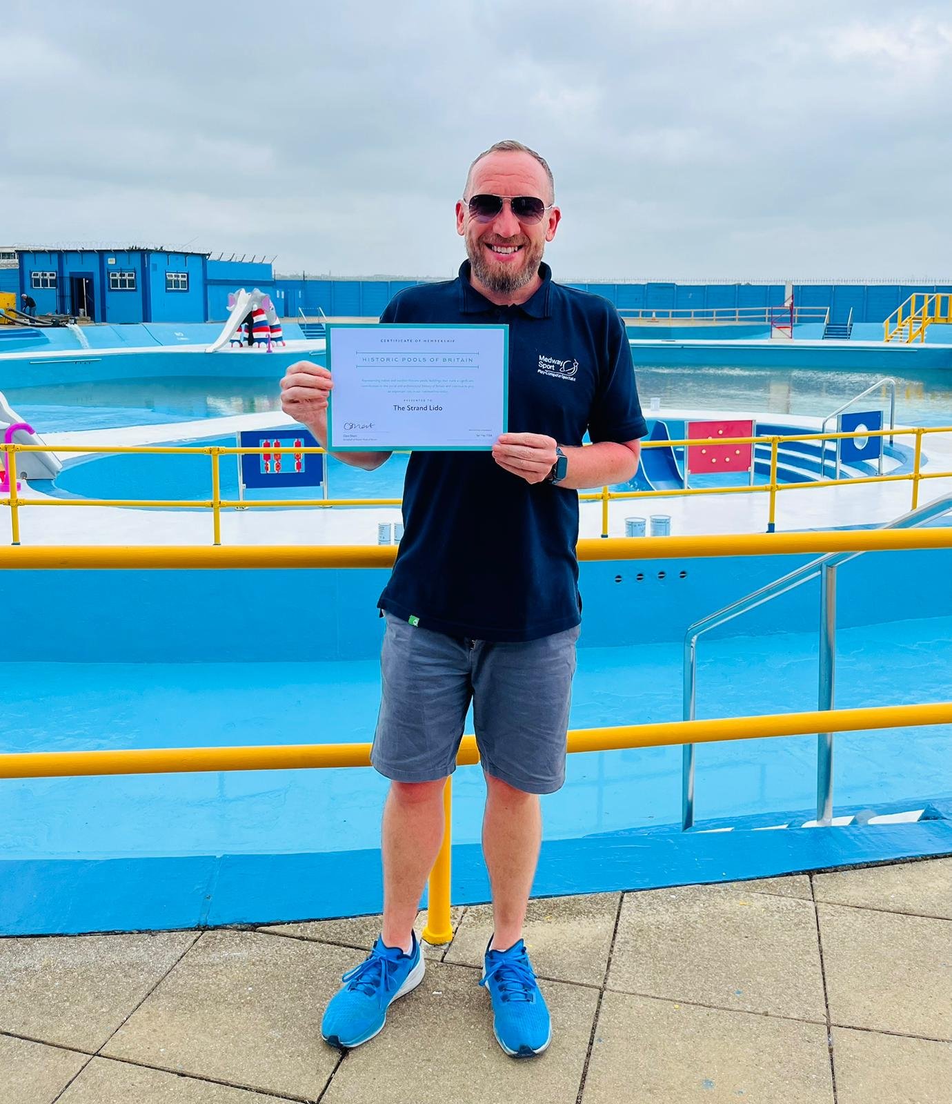 Paul Johnston, Medway Sport and Leisure Manager, at the Strand Lido with a certificate presented by Historic Pools of England